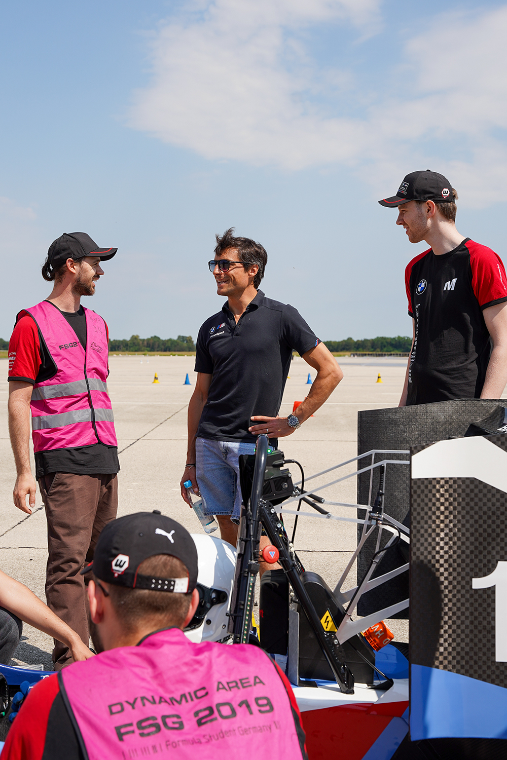 A group of Formula Student participants are talking.