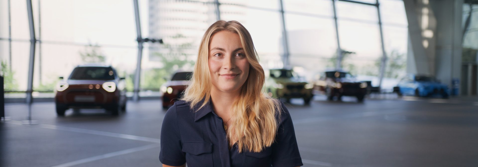 Fastlane participant Franca smiles warmly into the camera while giving an interview at BMW Welt.