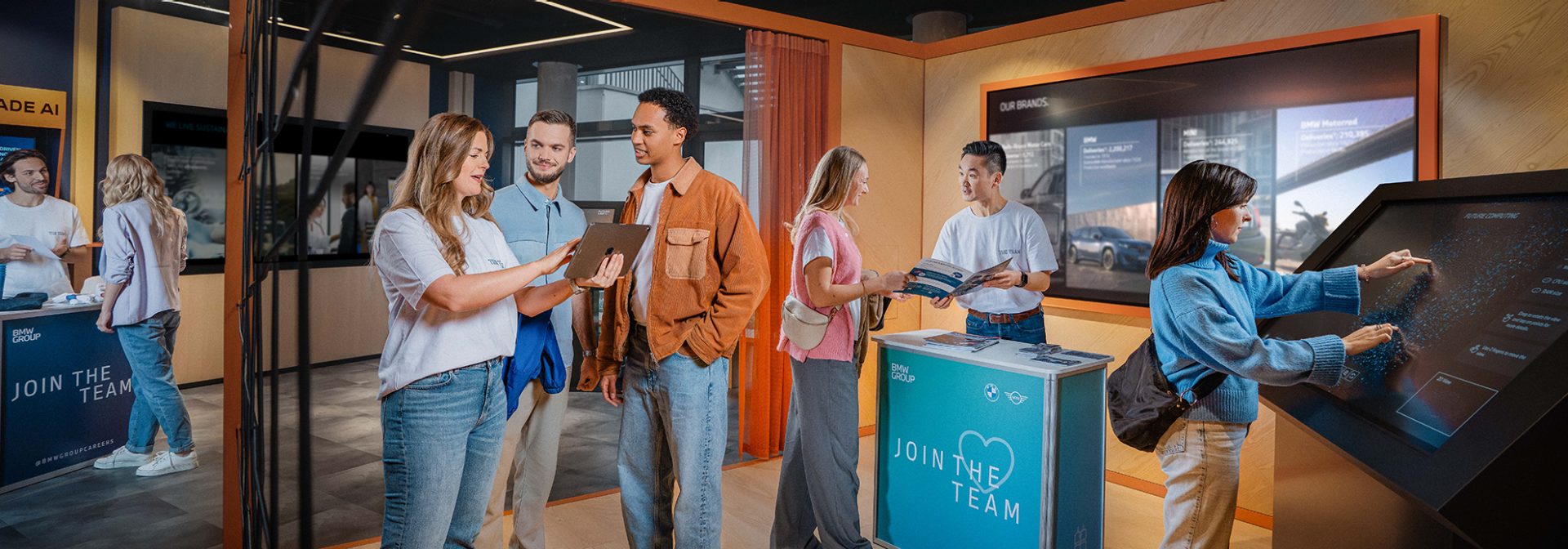 Students having a conversation at an BMW Group Event.