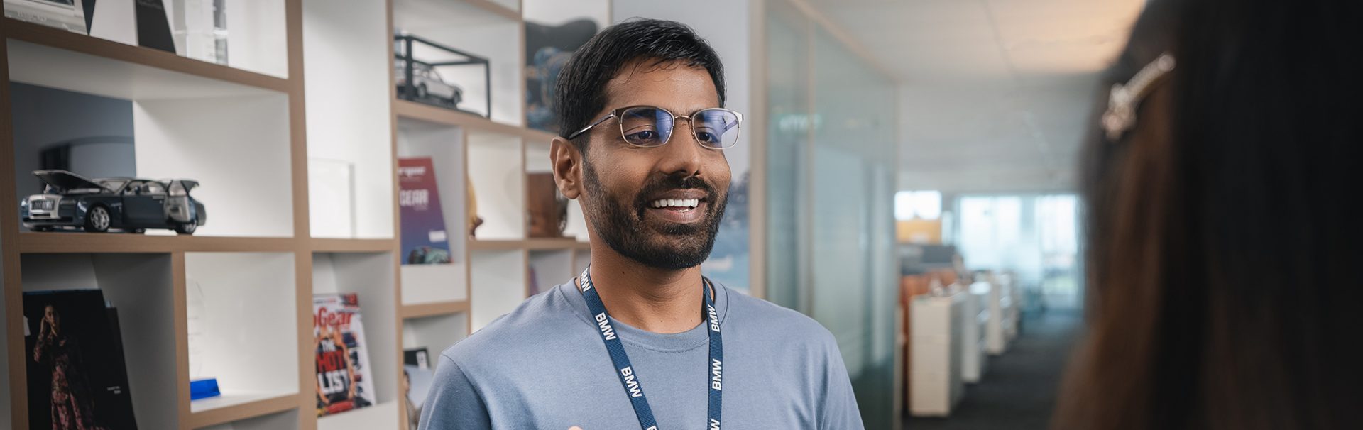 A BMW Employee laughing and talking to a colleague. 