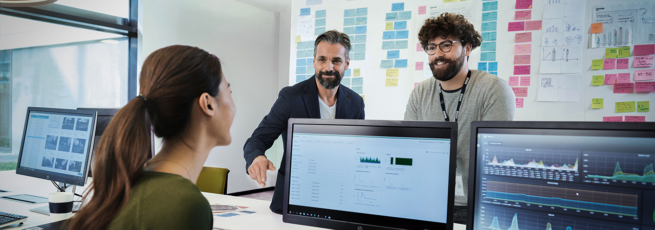 Three BMW professionals, a female one and two male ones, are meeting in an office to discuss a new project.    