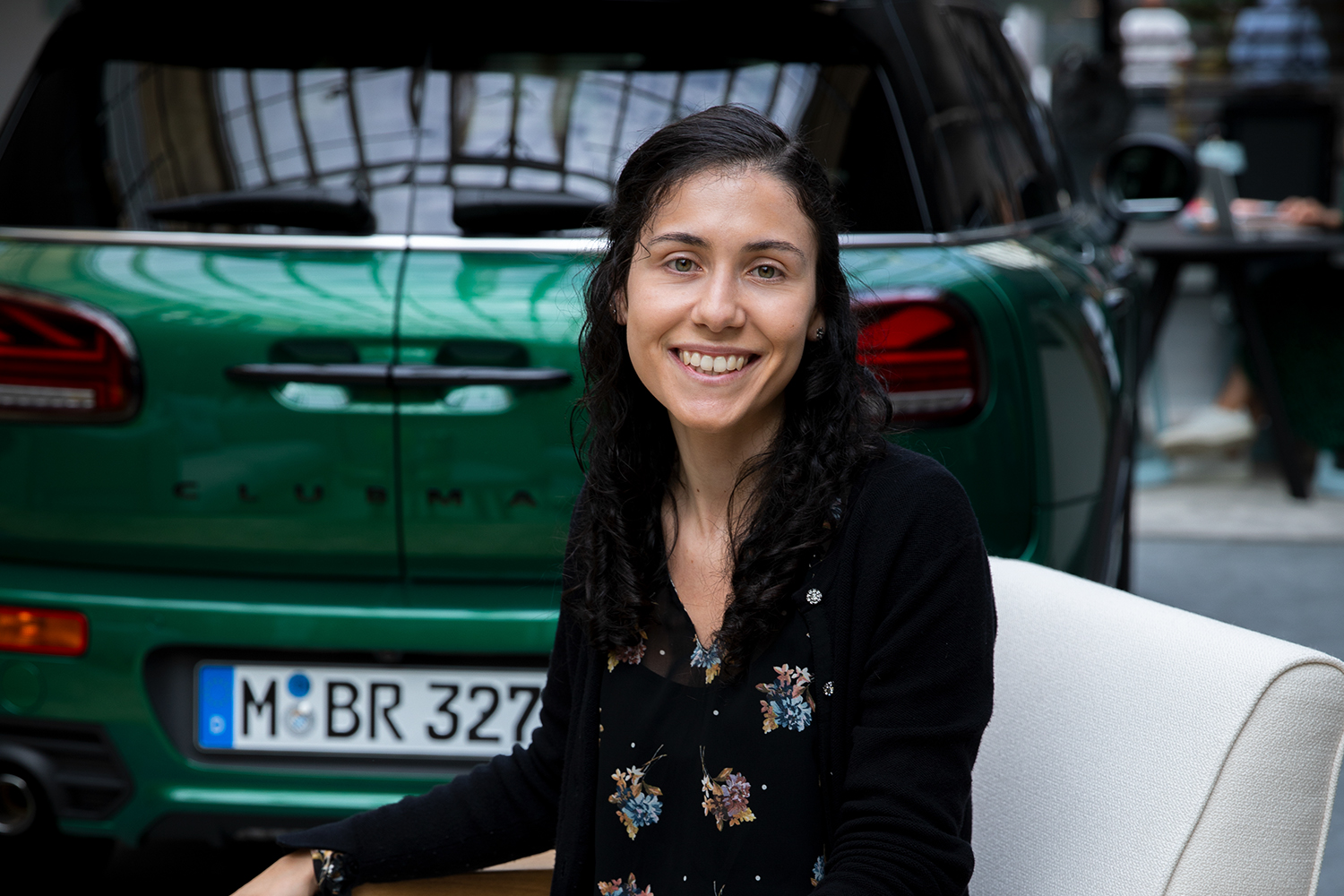 BMW Group recruiter Claudia in front of a green MINI Clubman