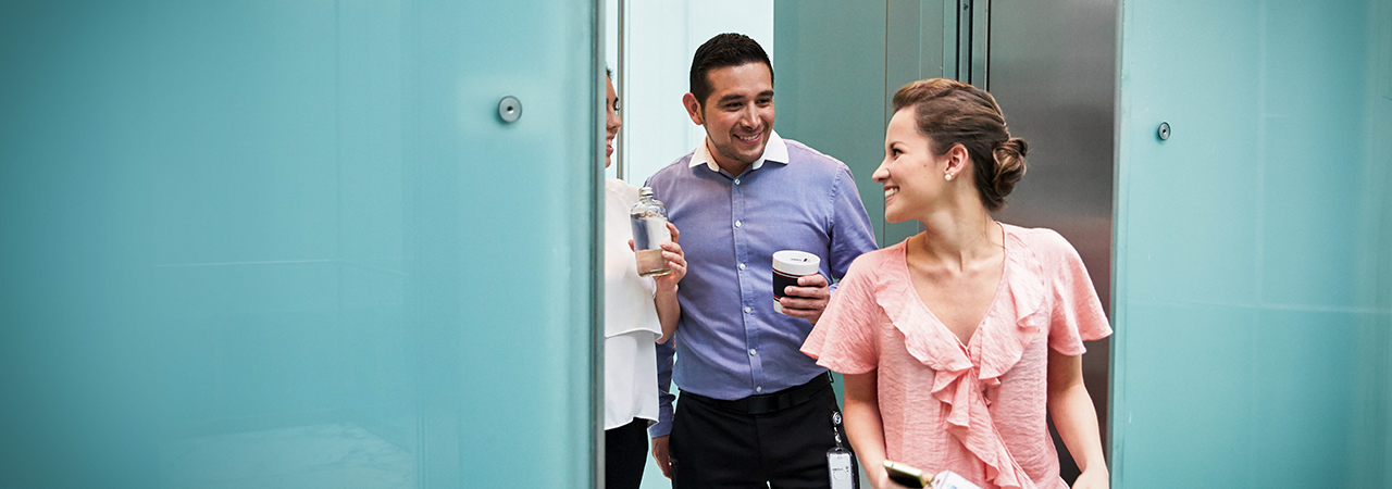 Three colleagues are talking about benefits.