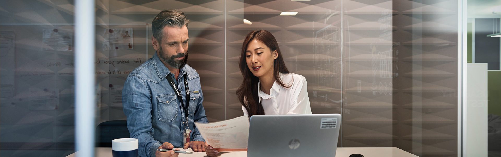 Two people in a dealership are talking to each other.