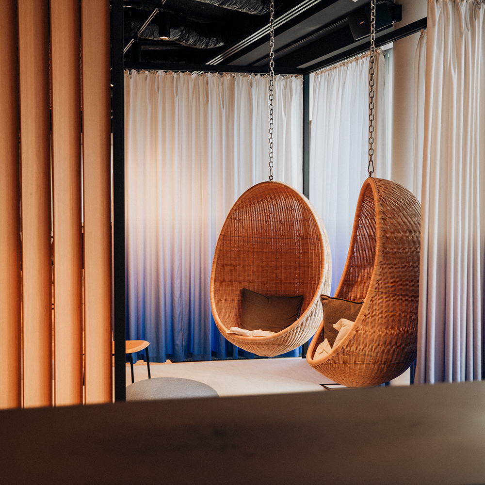 Two hanging chairs in an innovative office