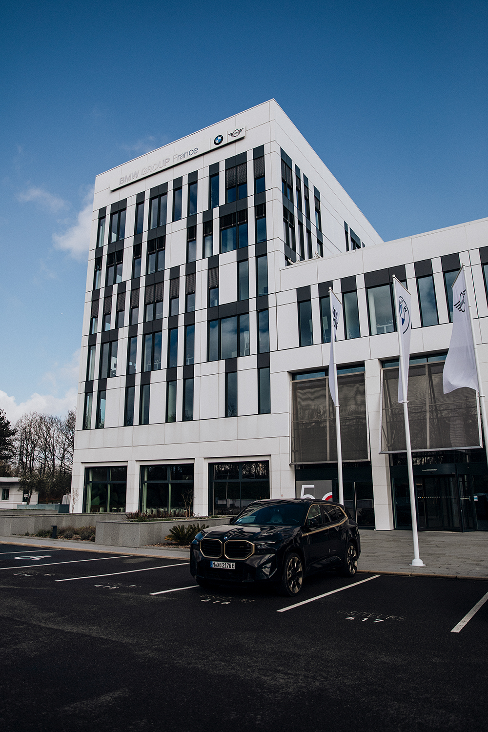 Exterior view of the Helice Campus with a BMW parked infrot of it.