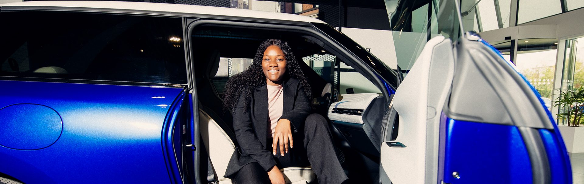 One of BMW Group's interns in a blue MINI