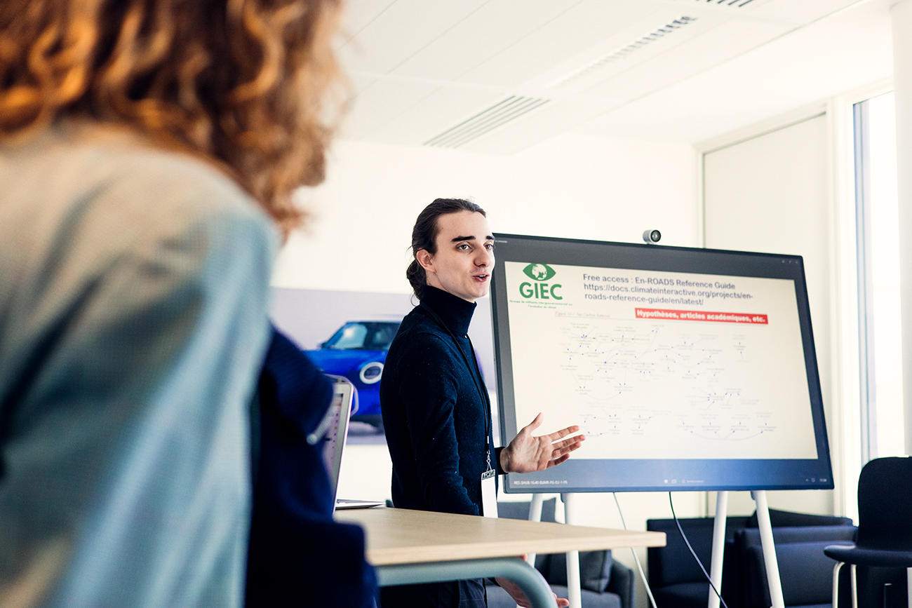 A student presenting ideas on a screen during a workshop