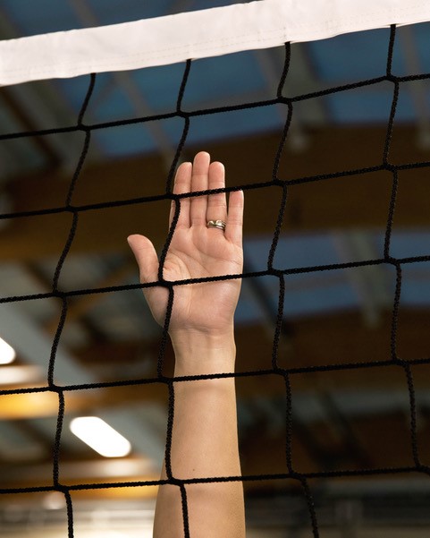 A hand on a handball net