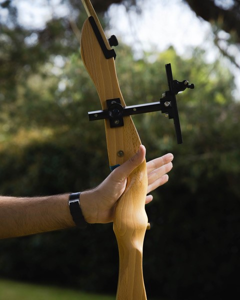 Close-up of a hand on a bow during archery