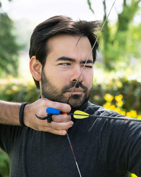 BMW employee Ozer, close-up of him practising archery