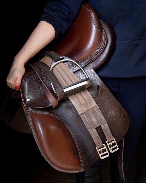 Close-up of a saddle being held in the hand