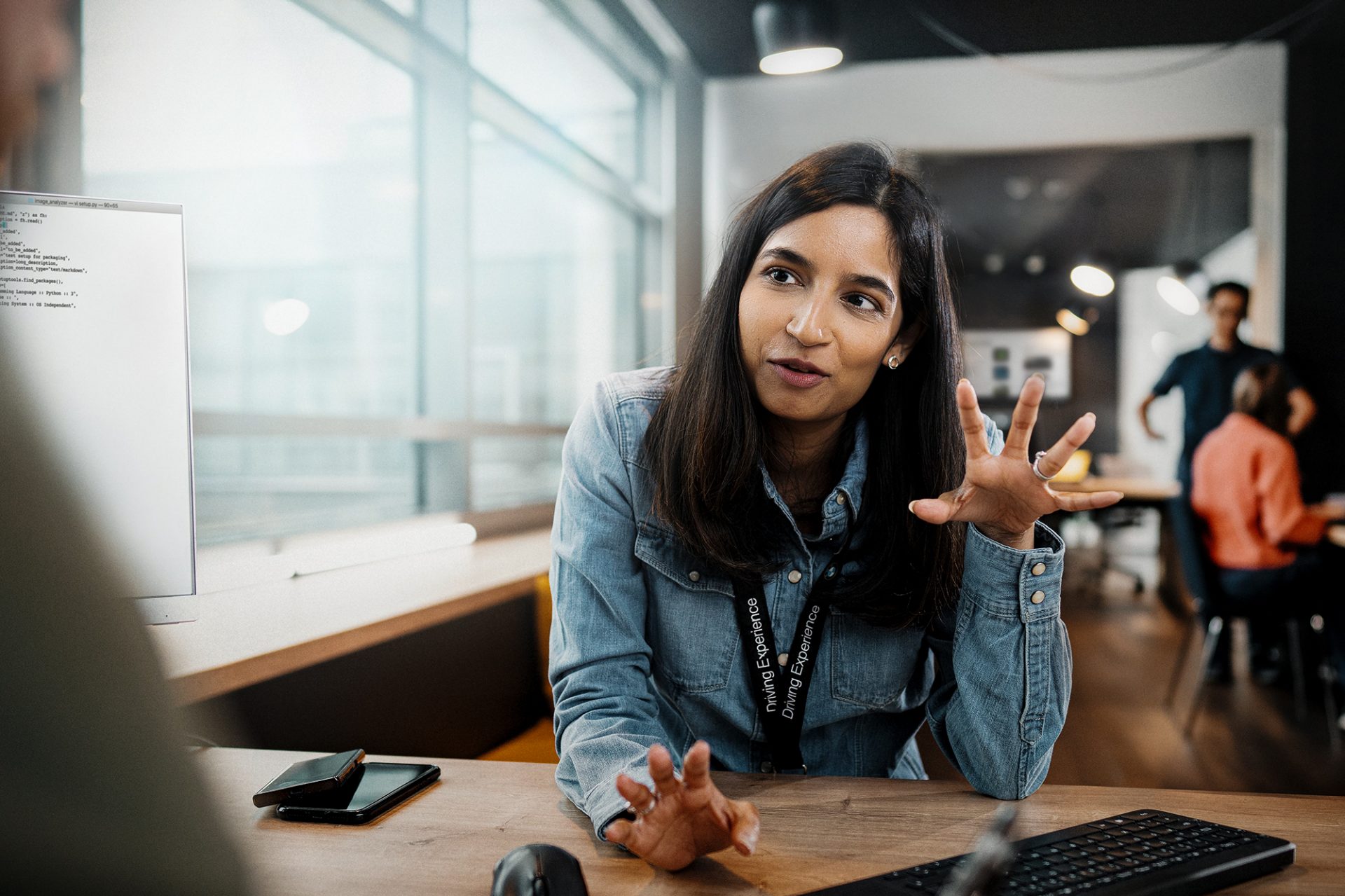 An IT employee gestures during a meeting
