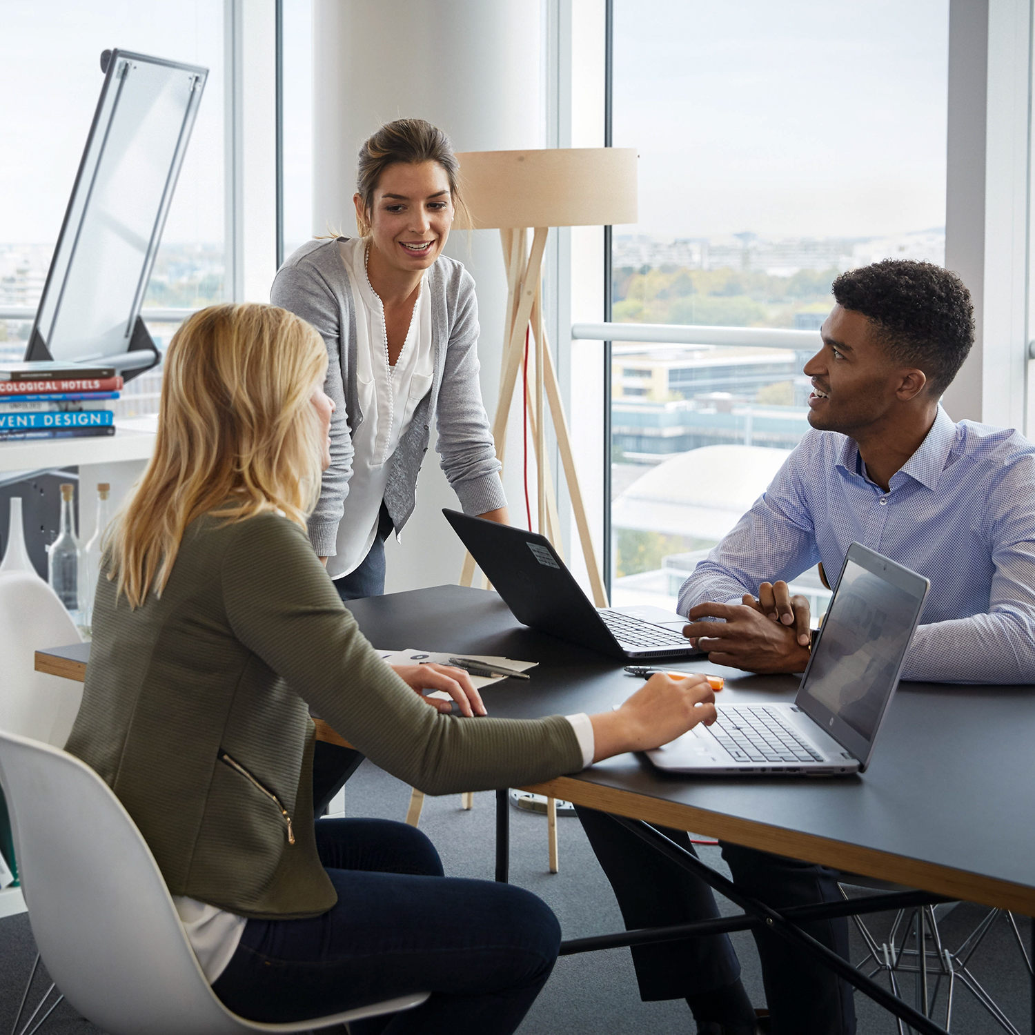 Three colleagues are having a conversation in the office.