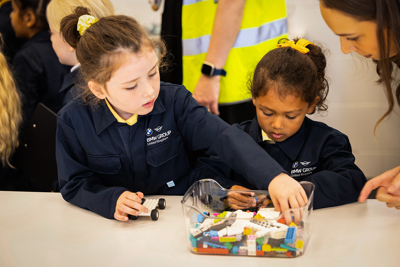 School students taking part in a hands-on technical workshop activity at BMW Group