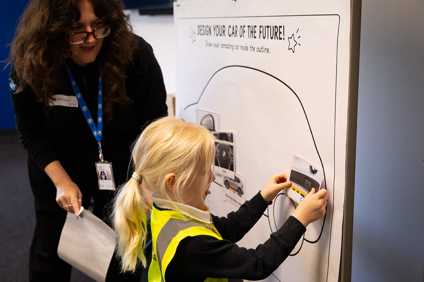School student presenting a vehicle design concept during a workshop activity at BMW Group.