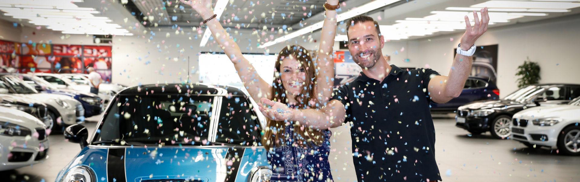 A colleagues picks up her new MINI and throws confetti