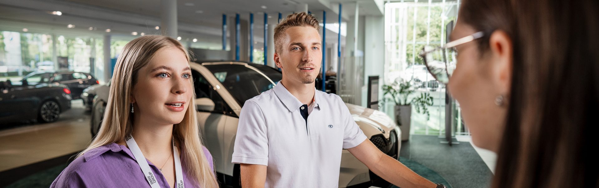 Three apprentices in a dealership having a conversation