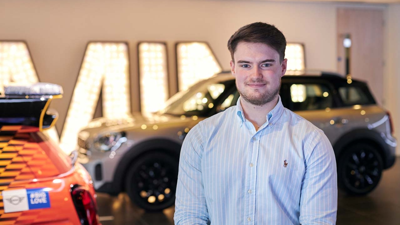 Ryan standing in front of a BMW car.