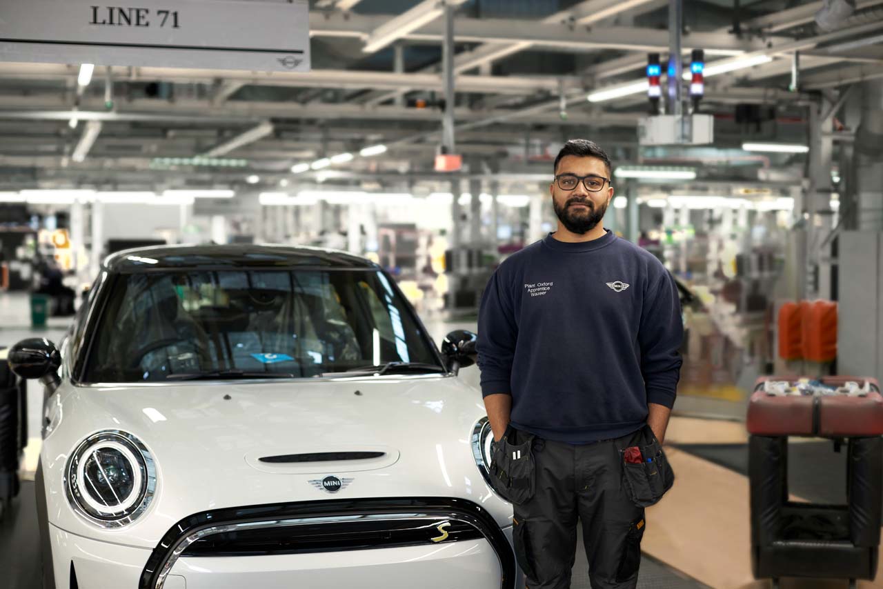 Wazeer standing by a MINI.