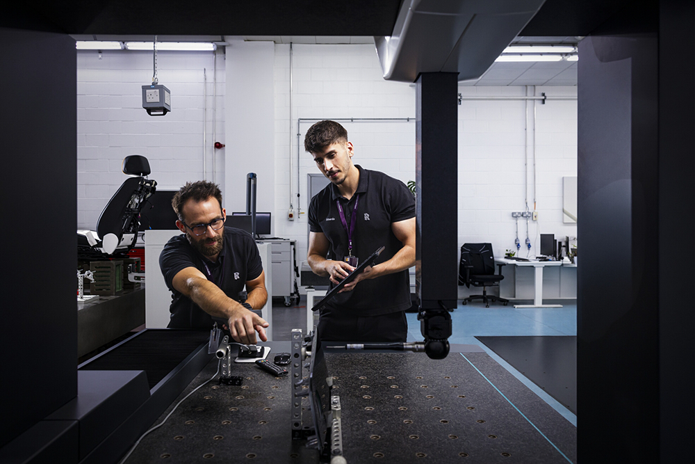 Employees conducting quality inspection activities in a technical workshop environment.