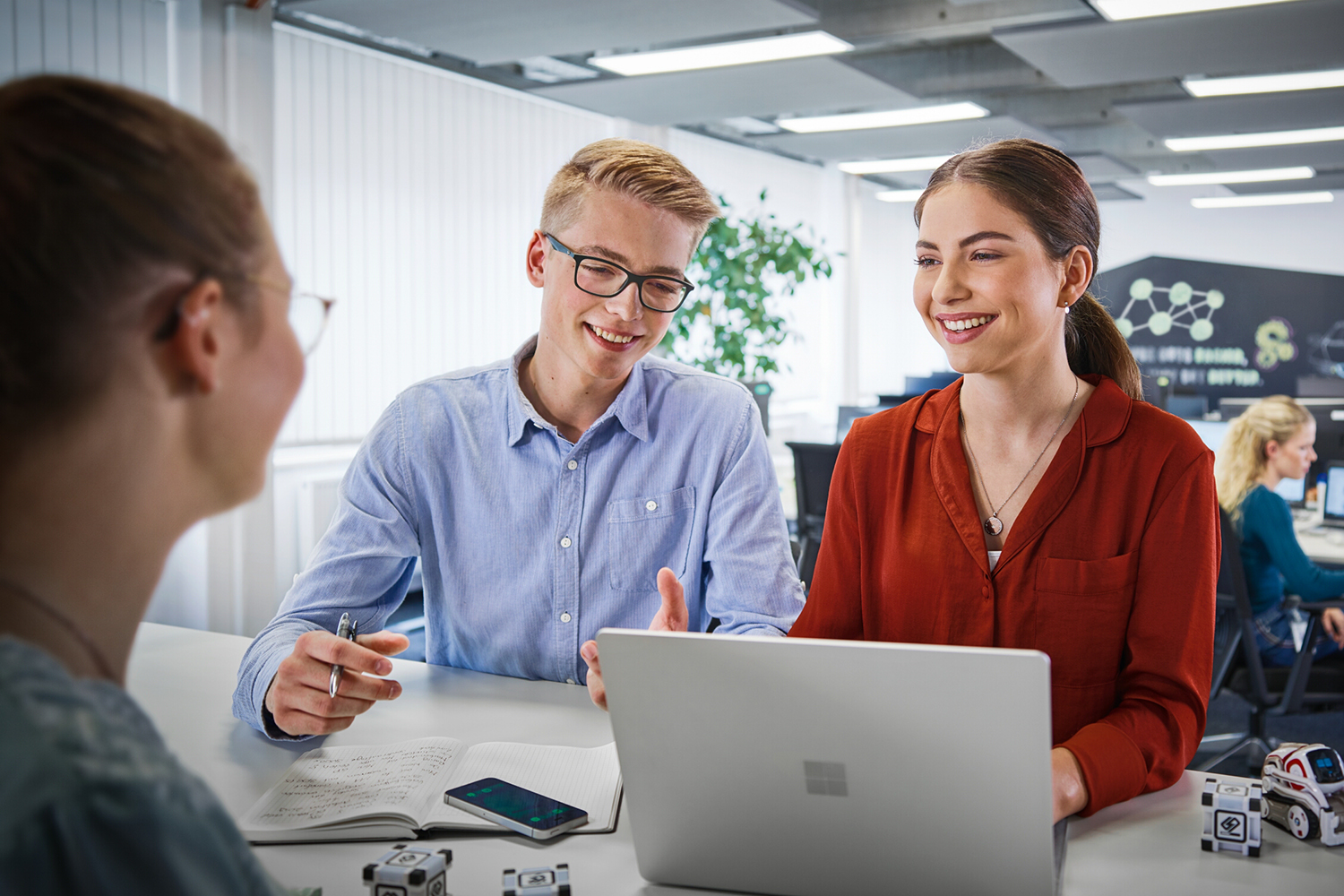 Two BMW Group apprentices are explaining the recruitment process to a candidate.