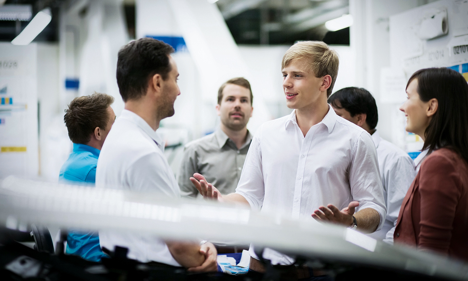 Colleagues in an Engineering environment having a chat.