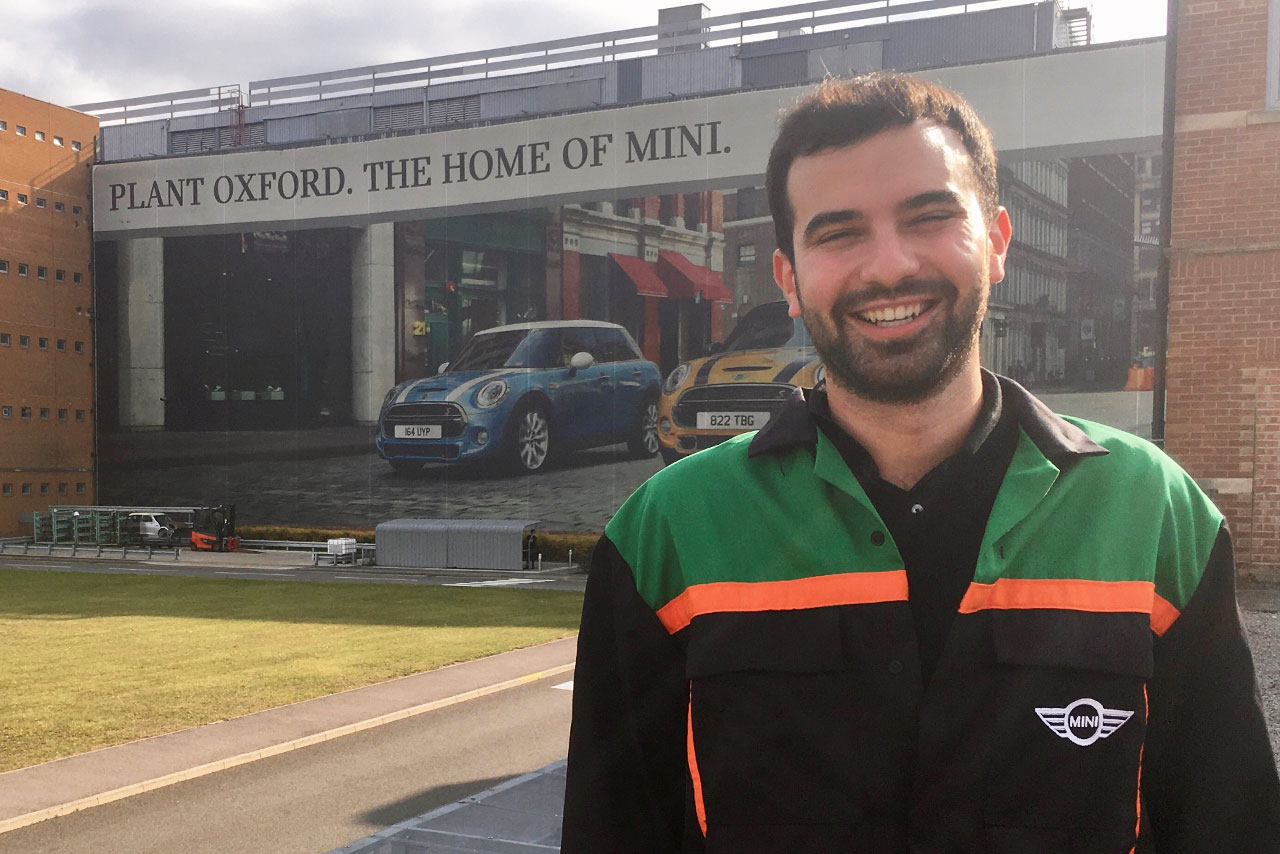 Sven a Logistics Planner outside in front of a giant Plant Oxford banner 