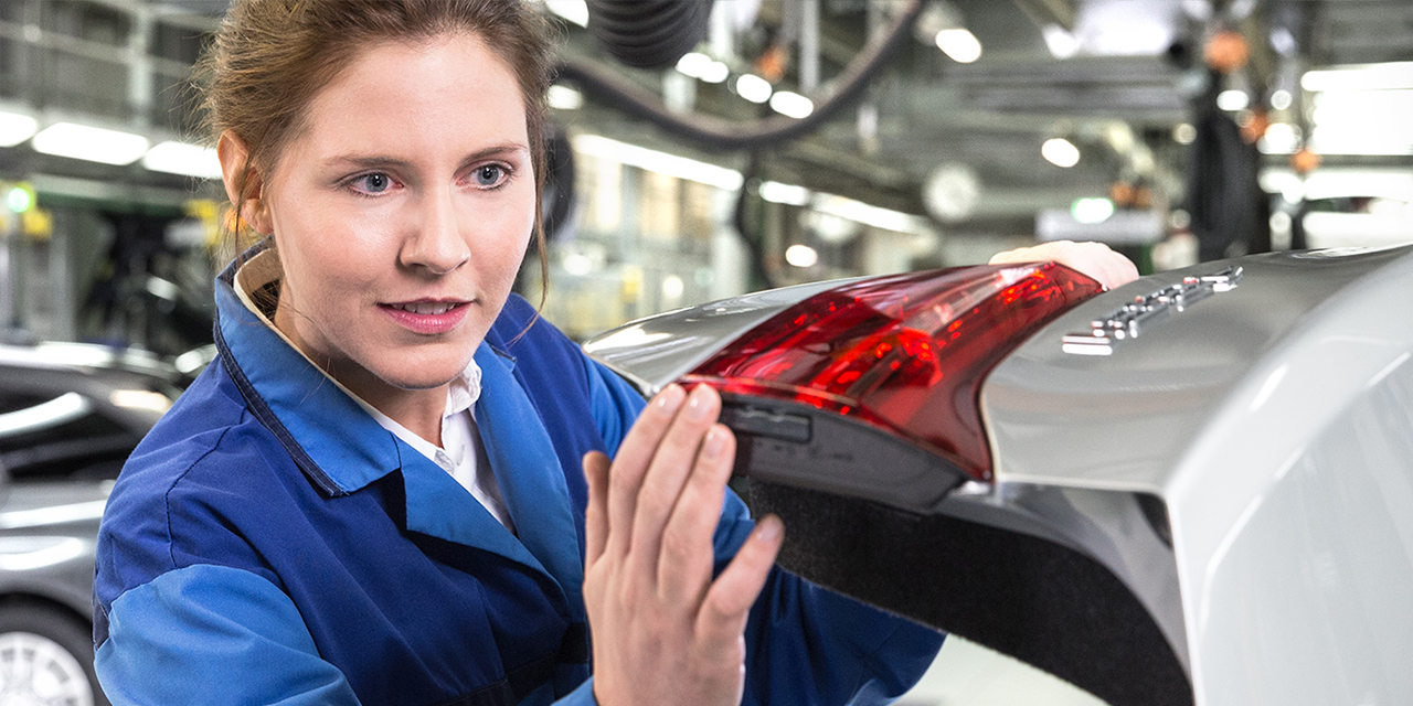 Two BMW quality employees checking a car