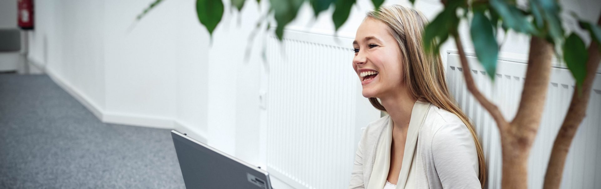 A female student works on a laptop and gains work experience at BMW.	