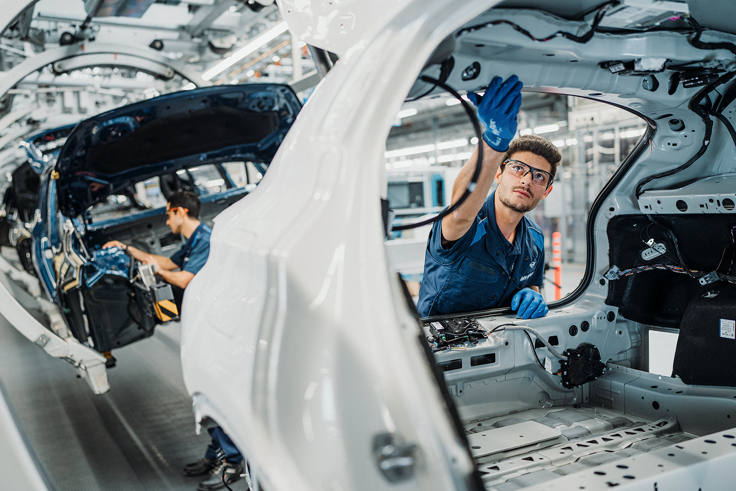 The picture shows a production worker on a BMW Group production line.