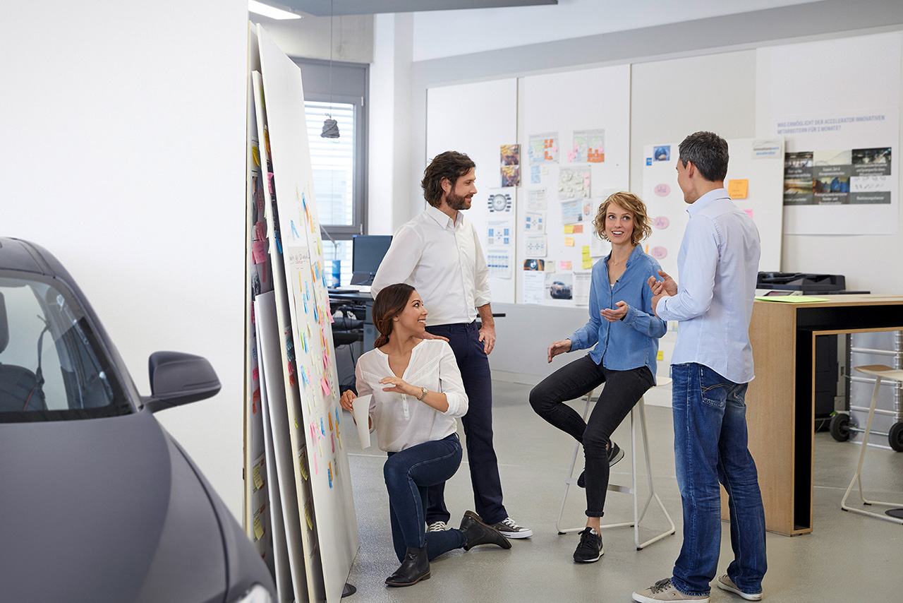 Four BMW employees working together on a project