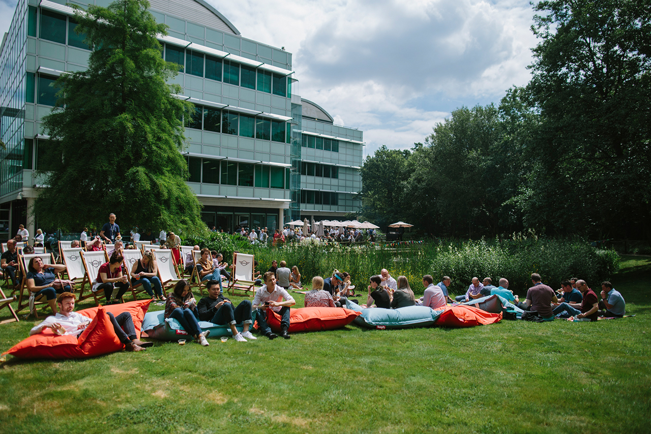 BMW and MINI employees enjoying their lunch break at the park in front of the office buildings in Farnborough