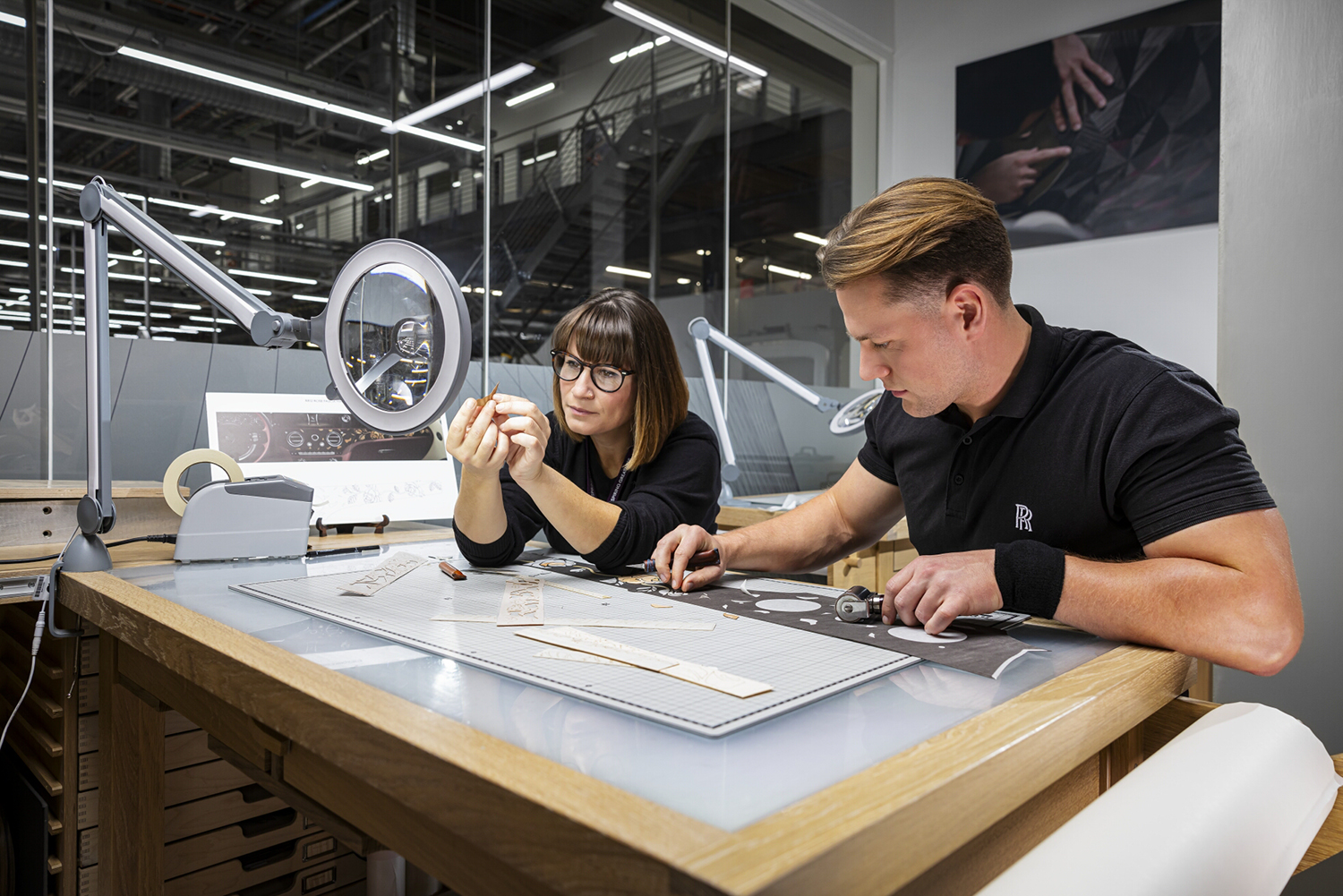Two Rolls Royce employees working on bespoke materials