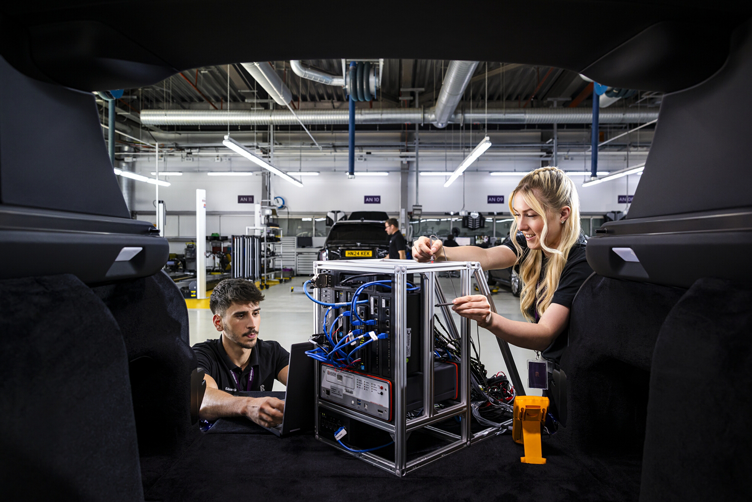 Two electrical engineers working in a Rolls Royce workshop