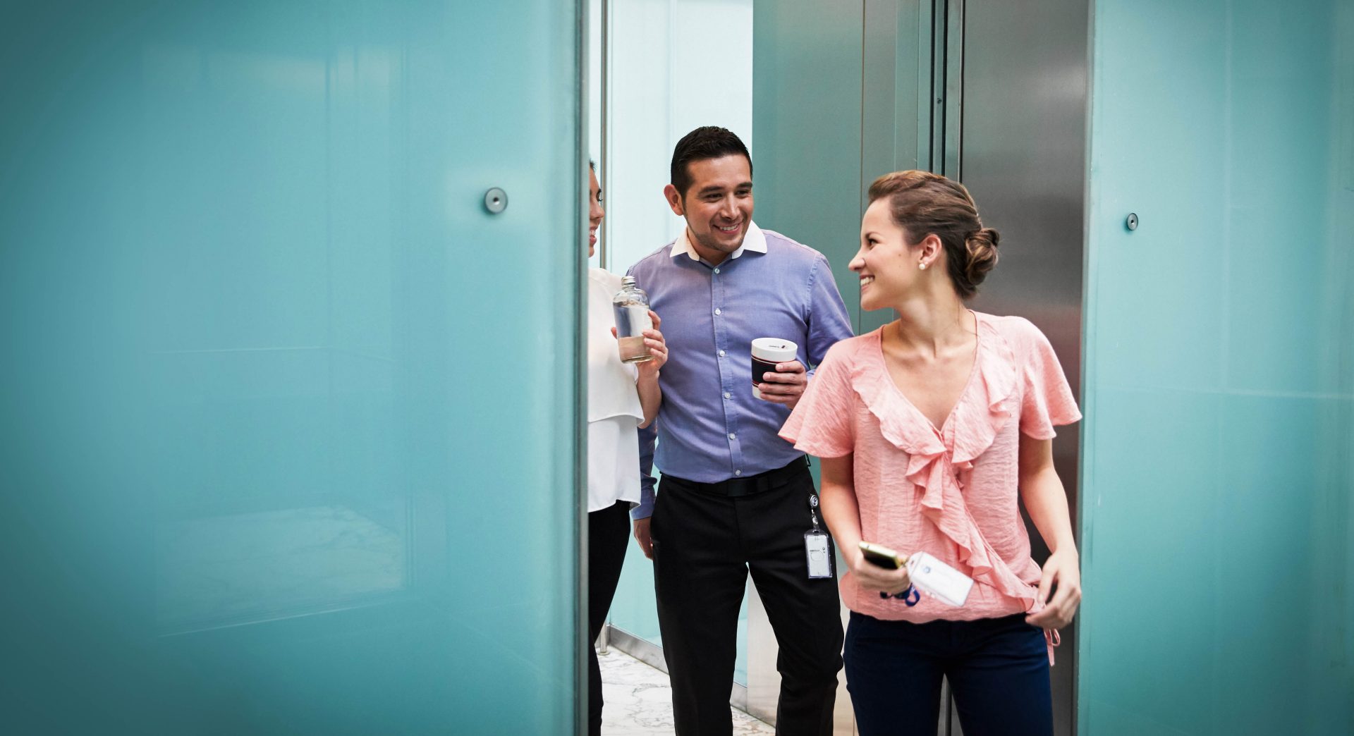 In this picture, a female professional explains the benefits of a BMW career to a young man.