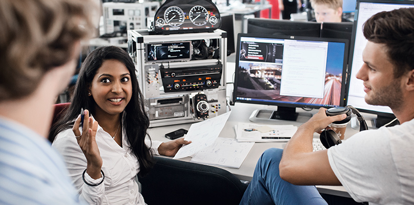  BMW IT professionals, two male ones and a female one, are attending a meeting.	