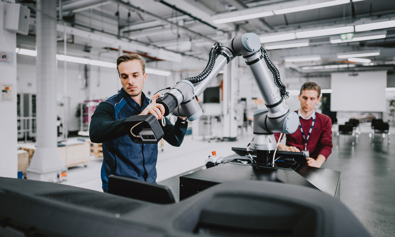 Two students working on a robot.