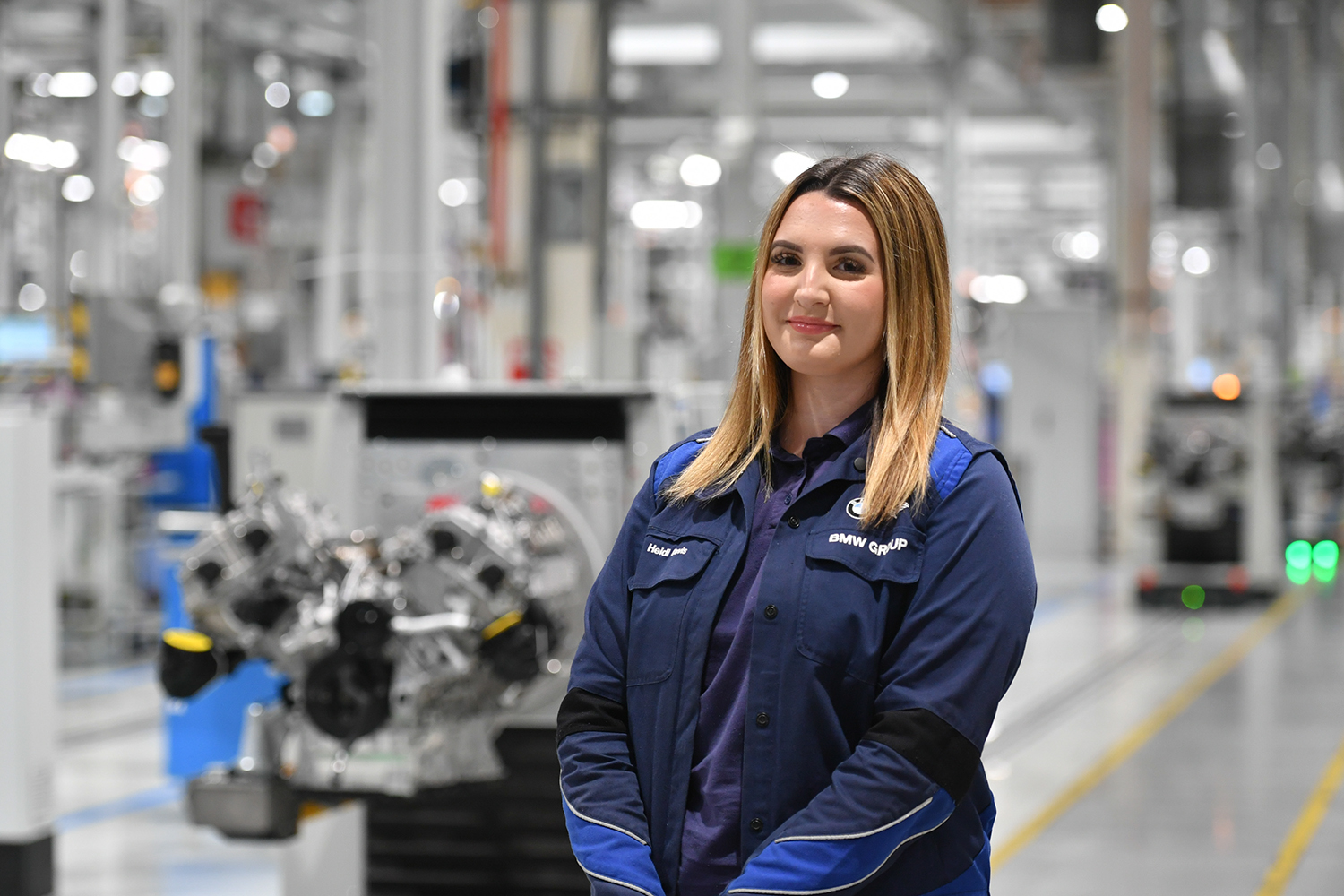 Intern Heidi, standing in the production hall