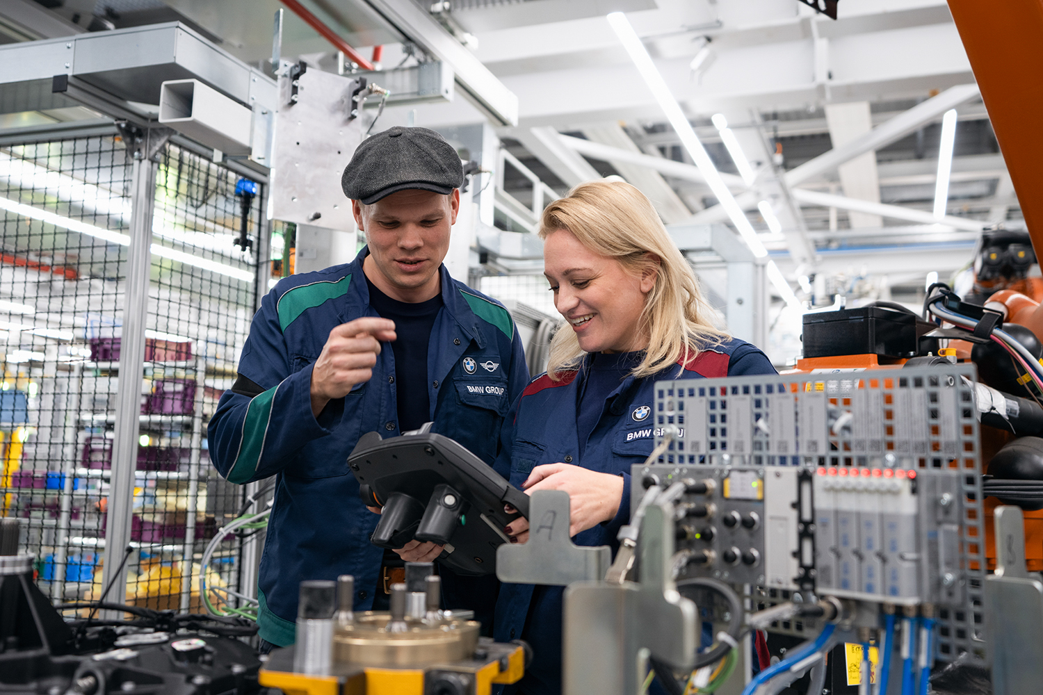 Two maintenance workers working with robots.