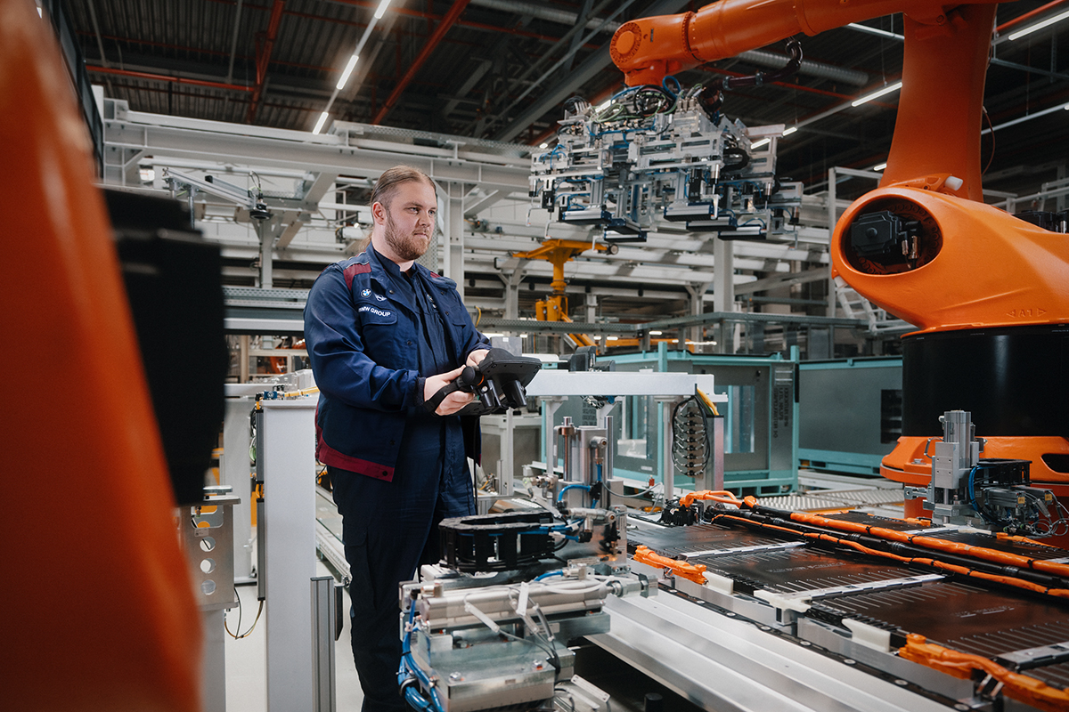 Maintenance Associate working with a robot