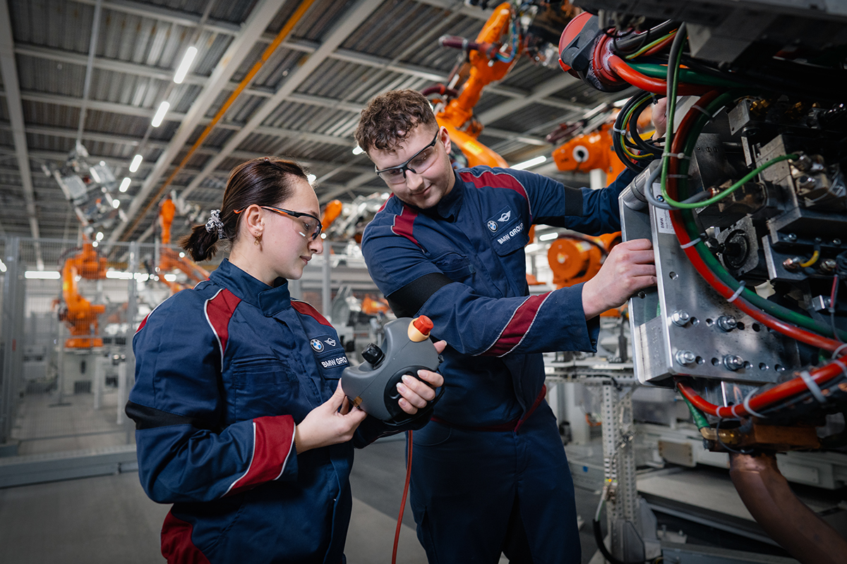 Maintenance Associate working with a robot