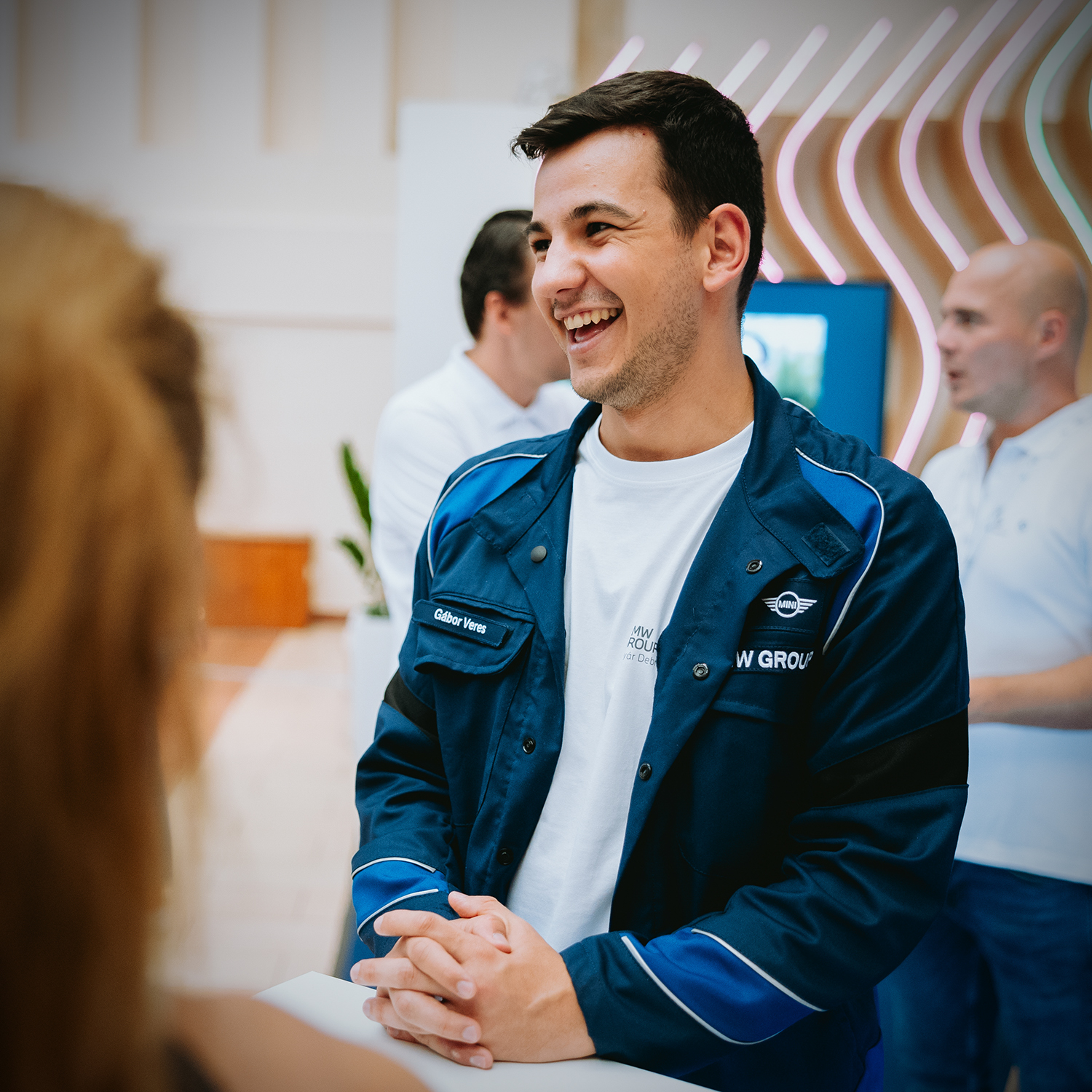 Recruiter talking to intersted applicants at a job fair.