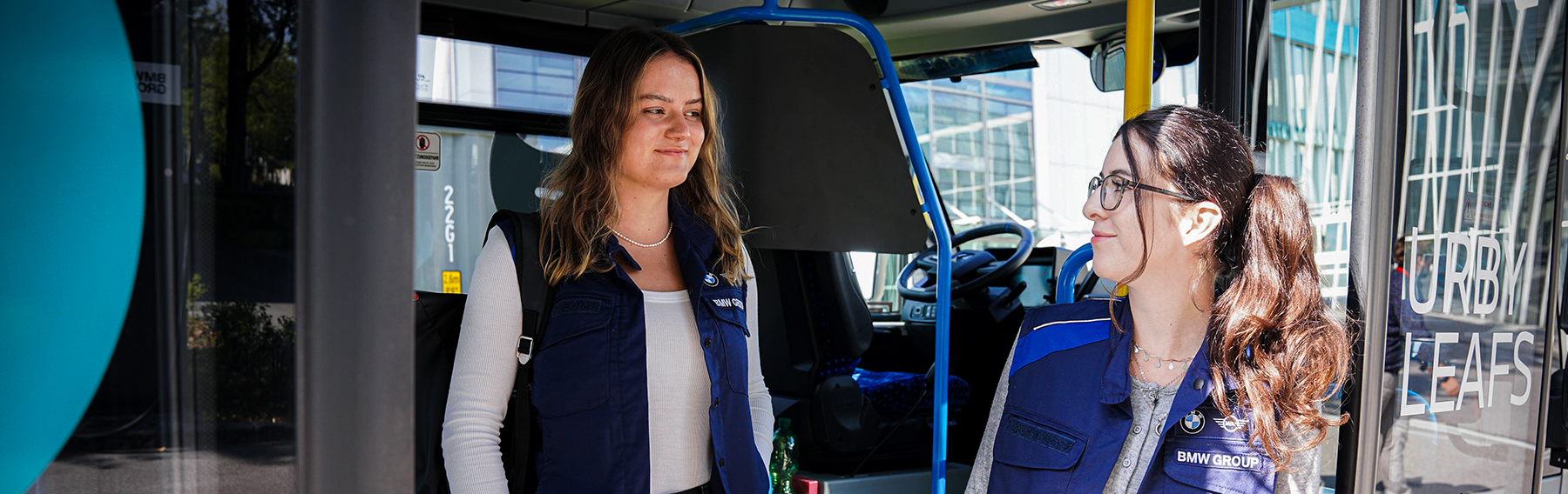 Two colleagues arriving at work with a bus