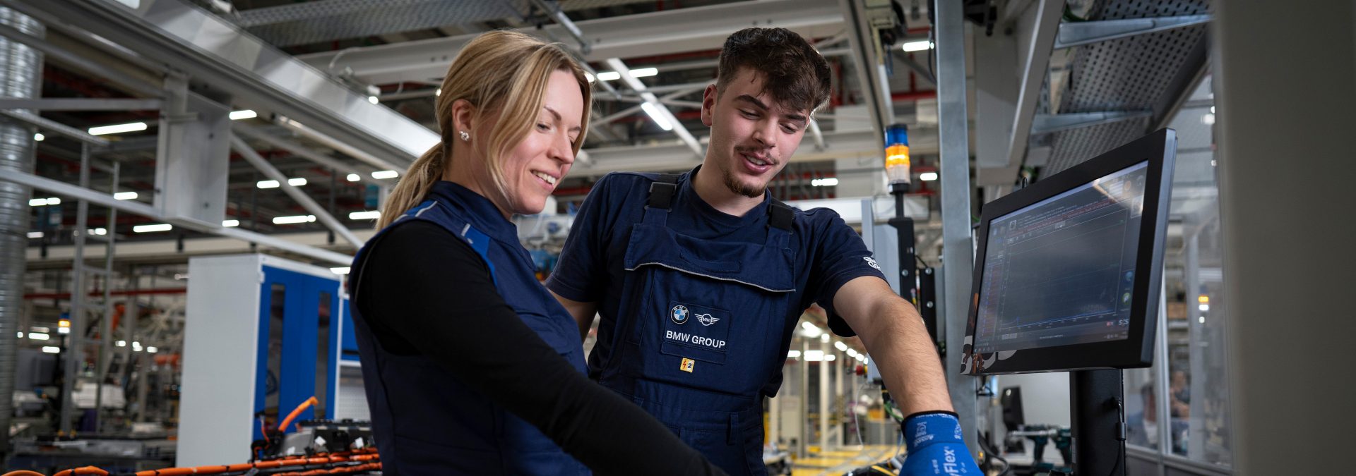 Two BMW Group technical apprentices at work.