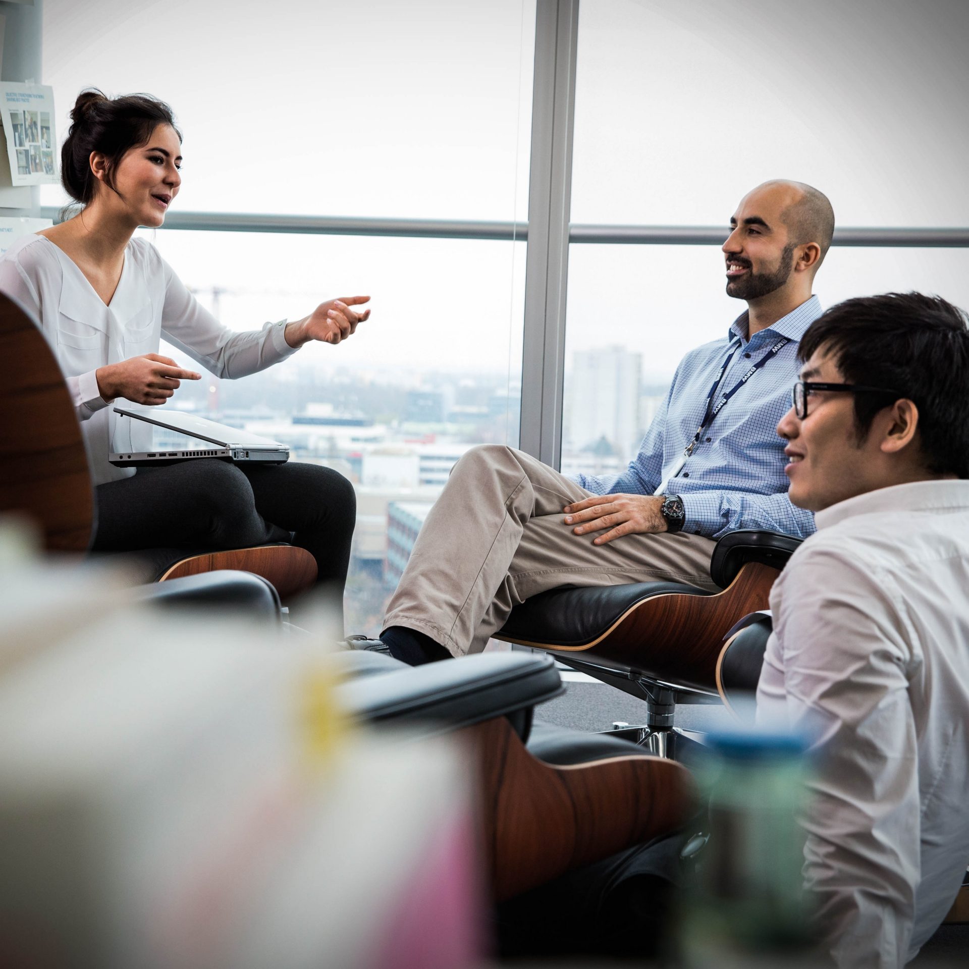 Three colleagues are having a conversation