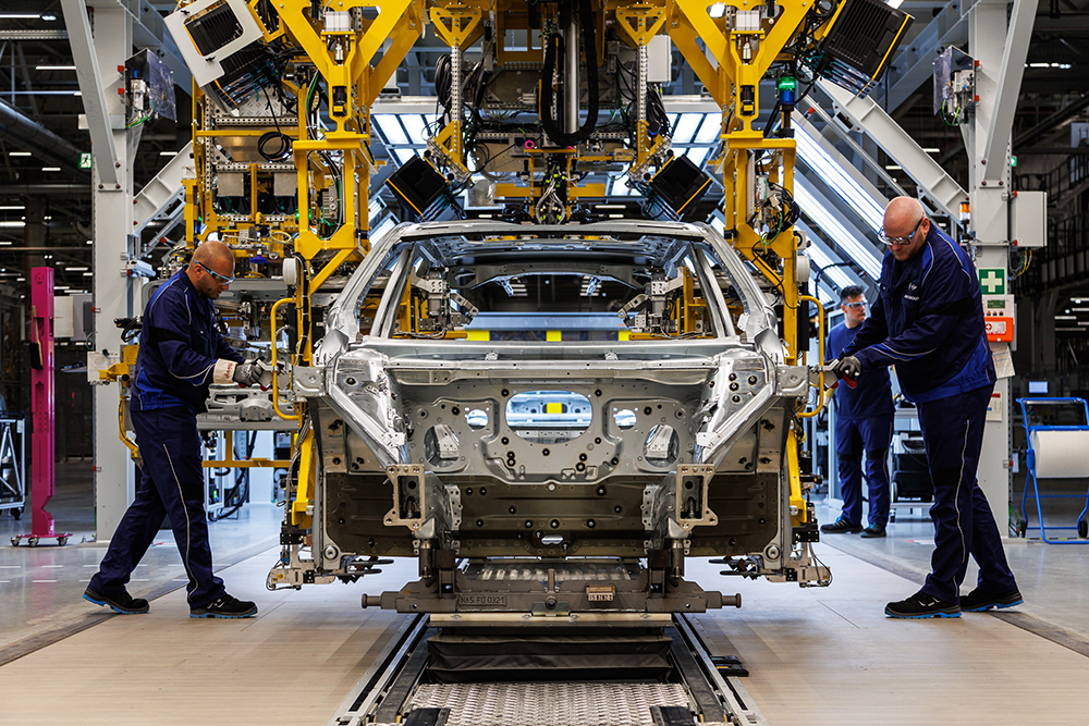 Bodyshop worker with a car body
