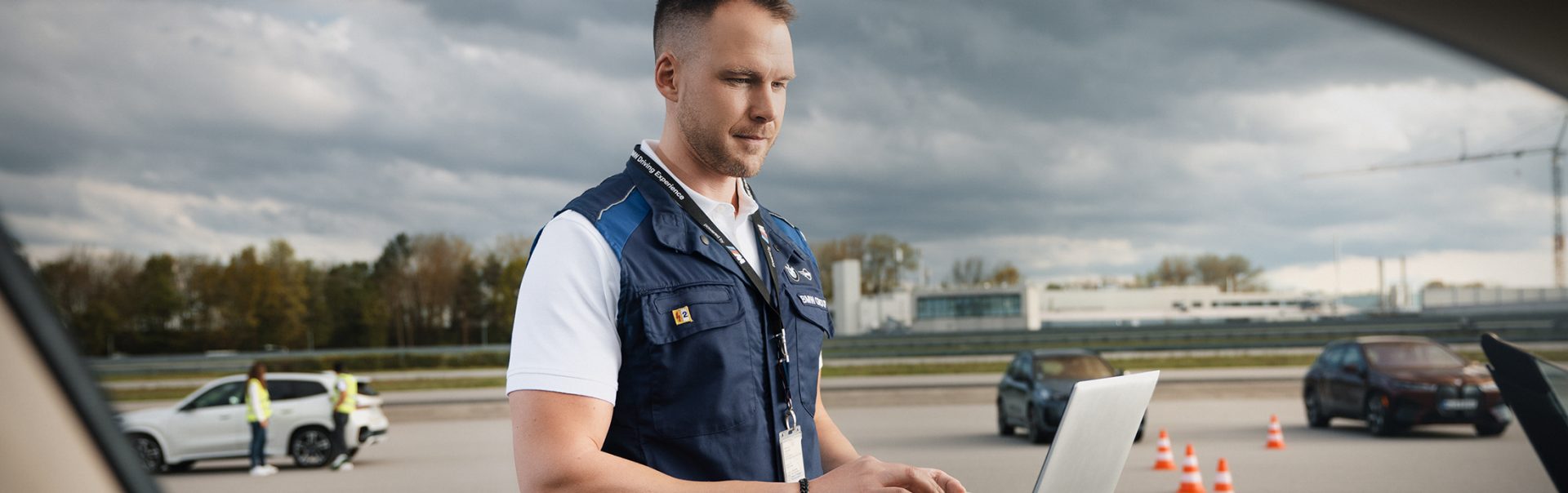 A colleague is working on a laptop on the test track.