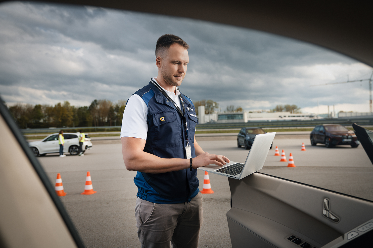 A colleague is working on a laptop on the test track.