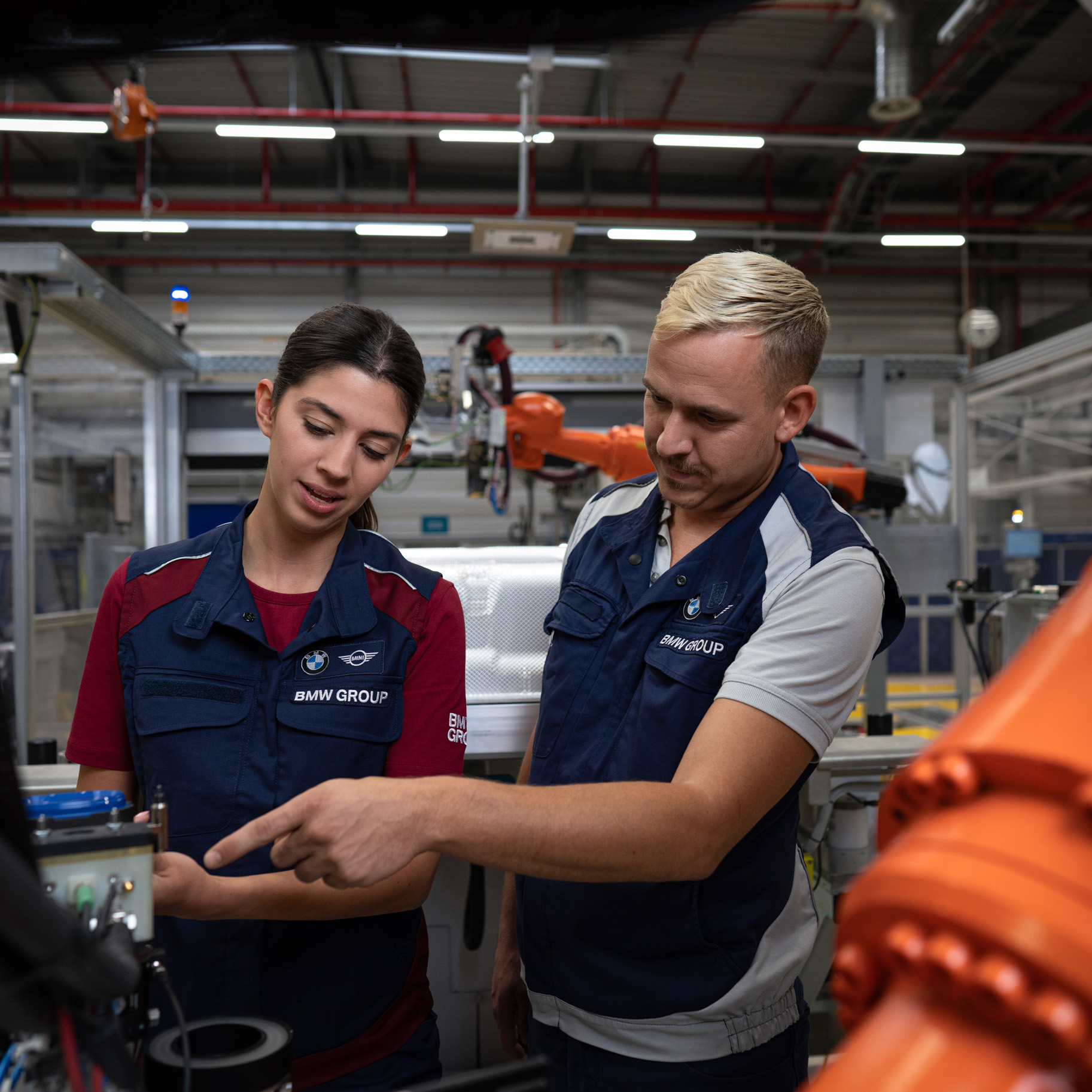 Two BMW Group team members at work.